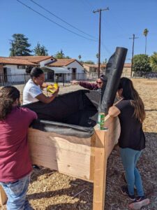 Community Members Help Line Raised Planting Beds